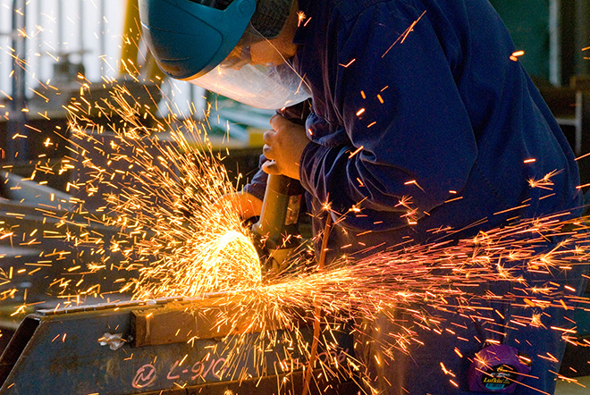 Industrial - Industrial scales a man grinding a metal piece